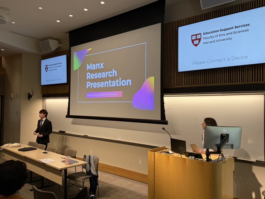 Misha Auchynnikau presenting the Manx Research Presentation at Harvard's Fong Auditorium, with Phoebe Austin at the podium